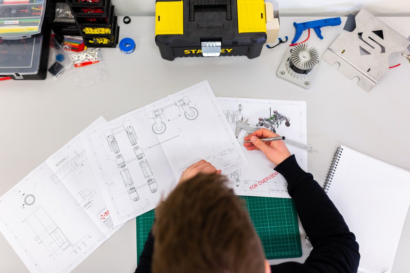 Blueprints and tools on an engineering training workbench